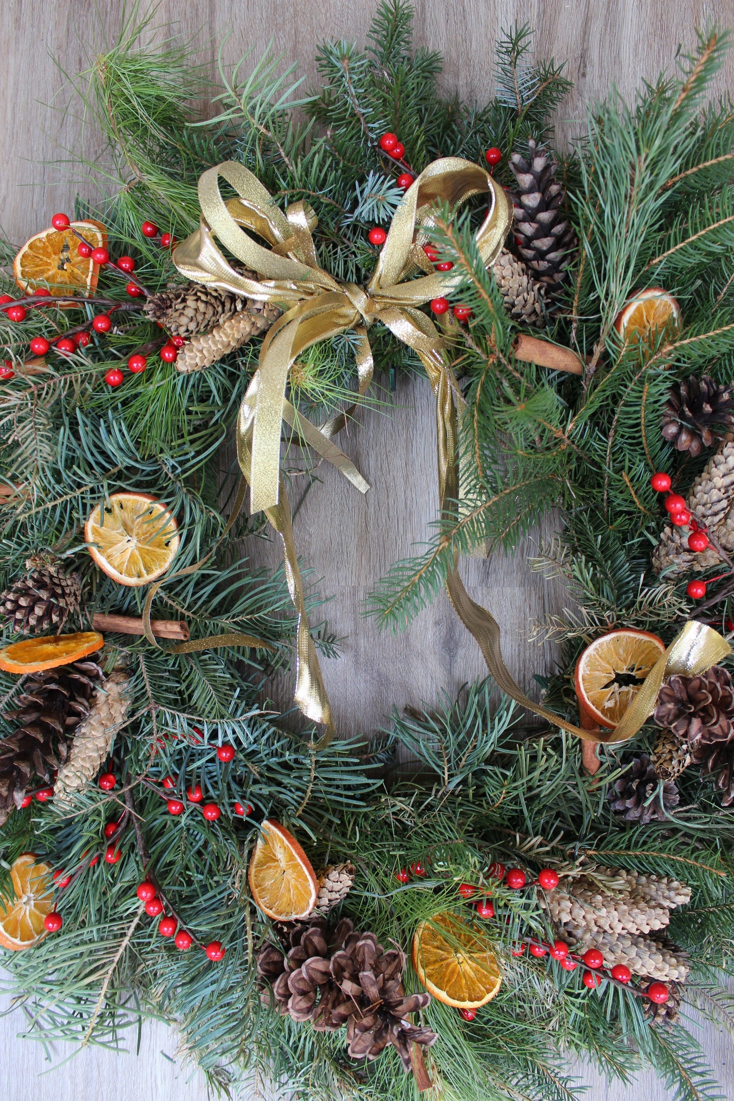 christmas wreath, rustic wreath, orange slices, pinecones, red berries, cinnamon